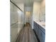 Bathroom featuring double sinks, a glass shower, and gray wood cabinets at 1521 Bat Hawk St, Las Vegas, NV 89138