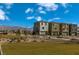 Street view of Quail Cove featuring new construction homes, lush landscaping, and community park at 1521 Bat Hawk St, Las Vegas, NV 89138