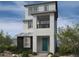 Contemporary three-story home with teal door and balcony at 1521 Bat Hawk St, Las Vegas, NV 89138