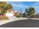 Single-story house with a two-car garage and mature landscaping at 1715 Mesquite Ct, Henderson, NV 89014