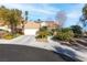 Single-story home with a two-car garage, landscaped yard, and solar panels at 1715 Mesquite Ct, Henderson, NV 89014