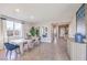 Dining room with light wood table and blue velvet chairs at 1921 Lewis Bay Ave # Lot 21, North Las Vegas, NV 89084