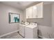 Convenient laundry room with white cabinets and washer/dryer at 1921 Lewis Bay Ave # Lot 21, North Las Vegas, NV 89084