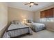 Spacious bedroom with two twin beds and a ceiling fan at 20 Via Mantova # 309, Henderson, NV 89011