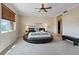 Main bedroom with circular bed, ceiling fan and large window at 20 Via Mantova # 309, Henderson, NV 89011