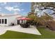 Landscaped backyard with patio furniture and red umbrella at 2000 Catalina Marie Ave, Henderson, NV 89074