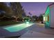 Night view of a refreshing pool and landscaped backyard with string lights at 2000 Catalina Marie Ave, Henderson, NV 89074