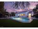 Tranquil backyard at dusk showcasing a sparkling pool and inviting patio area at 2000 Catalina Marie Ave, Henderson, NV 89074