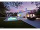 Evening view of the backyard with a pool, patio furniture, and string lights at 2000 Catalina Marie Ave, Henderson, NV 89074