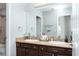 Bathroom with double vanity, dark brown cabinets, and a large mirror at 2000 Catalina Marie Ave, Henderson, NV 89074