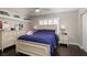 Bright bedroom with a double bed, built-in shelving, and hardwood floors at 2000 Catalina Marie Ave, Henderson, NV 89074