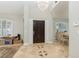 Elegant entryway with tile flooring, chandelier, and dark wood door at 2000 Catalina Marie Ave, Henderson, NV 89074