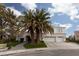 Two-story house with white exterior, palm trees, and a three-car garage at 2000 Catalina Marie Ave, Henderson, NV 89074