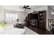 Gathering room featuring a sectional sofa, built-in shelving, and dark hardwood floors at 2000 Catalina Marie Ave, Henderson, NV 89074