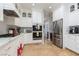 White kitchen with stainless steel appliances and granite countertops at 2000 Catalina Marie Ave, Henderson, NV 89074