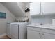 Bright laundry room with white cabinets and a utility sink at 2000 Catalina Marie Ave, Henderson, NV 89074