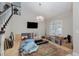 Living room with large TV, chandelier, and area rug at 2000 Catalina Marie Ave, Henderson, NV 89074