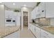 Modern kitchen with granite countertops, white cabinets, and a walk-in pantry at 2050 Cambridge Springs Dr, Henderson, NV 89052