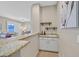 Home wet bar with granite countertop, white cabinets, and wine storage at 2050 Cambridge Springs Dr, Henderson, NV 89052