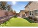 Artificial turf backyard with covered patio and retaining wall at 2124 Danzinger Pl, Henderson, NV 89044