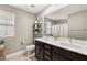 Bathroom features a double vanity and updated dark brown cabinets at 2124 Danzinger Pl, Henderson, NV 89044