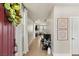 Bright entryway with a red door, hardwood floor, and artwork at 2124 Danzinger Pl, Henderson, NV 89044