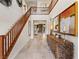 Bright entryway with tile flooring, wooden staircase, and contemporary console table at 2130 Maderno St, Henderson, NV 89044