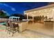 Outdoor kitchen and bar with seating area at 2130 Maderno St, Henderson, NV 89044