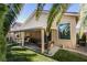 Covered patio, grassy area and palm trees at 2132 Timber Rose Dr, Las Vegas, NV 89134