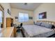 Spacious bedroom with large bed, desk, and mirror at 2132 Timber Rose Dr, Las Vegas, NV 89134