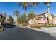 Gated entrance to Country Rose Estates, featuring palm trees and lush landscaping at 2132 Timber Rose Dr, Las Vegas, NV 89134