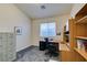 Home office with wood desk, window, and built-in shelving at 2132 Timber Rose Dr, Las Vegas, NV 89134