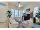 Bright living room with sectional sofa, large TV, and ceiling fan at 2132 Timber Rose Dr, Las Vegas, NV 89134