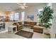 Bright living room with L-shaped sectional & ceiling fan at 2132 Timber Rose Dr, Las Vegas, NV 89134