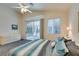 Main bedroom with sliding glass doors to the patio, a large bed, and plenty of dresser space at 2132 Timber Rose Dr, Las Vegas, NV 89134