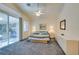 Main bedroom with sliding glass doors to the patio, a large bed, and plenty of dresser space at 2132 Timber Rose Dr, Las Vegas, NV 89134