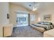 Main bedroom with sliding glass doors to the patio, a large bed, and plenty of dresser space at 2132 Timber Rose Dr, Las Vegas, NV 89134