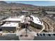 Stunning aerial view of a community center with ample parking and desert landscaping against a mountain backdrop at 2255 Potter Lake Ave, Henderson, NV 89052