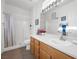 Bright bathroom featuring a tiled shower and light wood vanity at 2255 Potter Lake Ave, Henderson, NV 89052