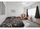 Bright bedroom features a ceiling fan, an accent chair, and a view of the window at 2255 Potter Lake Ave, Henderson, NV 89052