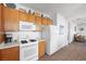 White appliances and wood cabinets in this well-lit kitchen at 2255 Potter Lake Ave, Henderson, NV 89052