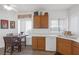 Kitchen featuring wood cabinets, stainless steel dishwasher, and tiled flooring at 2255 Potter Lake Ave, Henderson, NV 89052