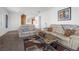 Living room with two beige leather sofas, a coffee table, and a view into kitchen at 2255 Potter Lake Ave, Henderson, NV 89052