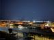 A serene rooftop view at night, showcasing the neighborhood's illuminated homes from a cozy seating area at 2255 Potter Lake Ave, Henderson, NV 89052