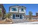 Two-story home with gray exterior, blue shutters, and a paved driveway at 2641 Snapdragon Falls Ave # 106, North Las Vegas, NV 89081