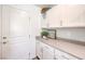 Bright laundry room with white cabinets and granite countertops at 2641 Snapdragon Falls Ave # 106, North Las Vegas, NV 89081