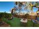 Landscaped backyard with artificial turf, seating, and plants at 2694 Kinghorn Pl, Henderson, NV 89044