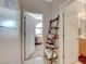 Well-lit hallway with linen shelves and access to bedroom and bathroom at 2694 Kinghorn Pl, Henderson, NV 89044