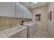 Bright laundry room, washer, dryer, and storage cabinets at 2694 Kinghorn Pl, Henderson, NV 89044