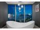 Spa-like bathroom with a free-standing tub and nighttime city views at 2700 Las Vegas Blvd # 809, Las Vegas, NV 89109